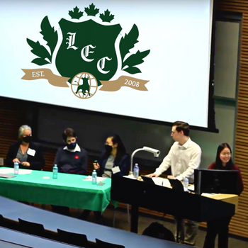 A table of panelists and the moderators of LEC's Great Economic Debate