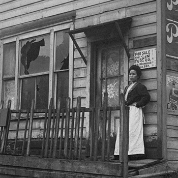 Woman standing in front of a broken window