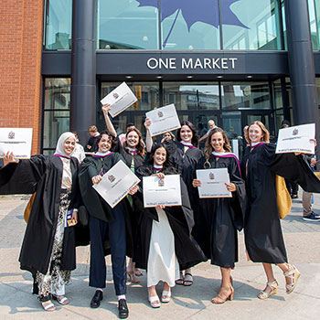 Graduates in front of One Market