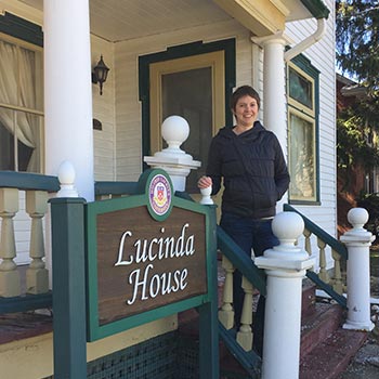 Ashley Little in front of Lucinda House